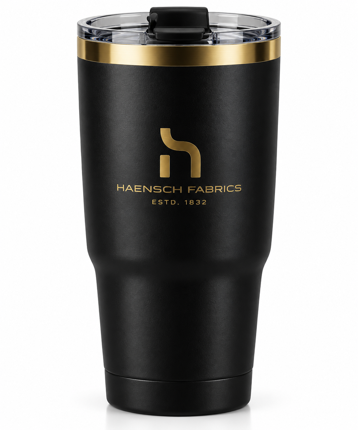 Matte black Haensch Coast insulated tumbler with gold H logo, gold accent ring and clear lid on a white background.
