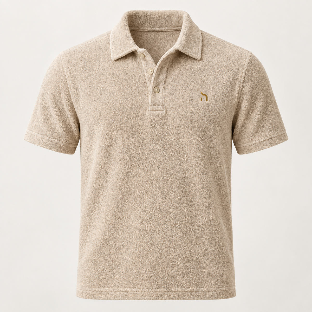Haensch Coast Terry Polo Herren in Coast Sand aus weichem Frottee mit Polokragen und goldenem Haensch-Zeichen.
